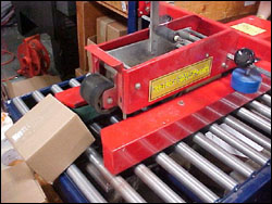 This machine applies the tape to the box tops, which reduces the likelihood of repetitive motion injuries to employees. 