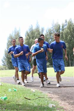 Cadets from Kalaheo High School Navy junior reserve officer training corps quench their thirst in a formation run as they reach the halfway mark during the 12th Annual 5K Grueler Sept. 17.  