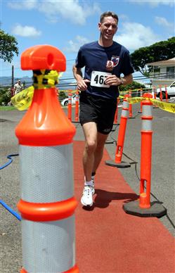 Herman Welch takes his last winding steps while crossing the finish line during the 12th Annual 5K Grueler Sept. 17.  