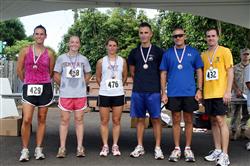 Overall top three runners in the male and female category take their place in the winners circle during the 12th Annual 5K Grueler Sept. 17.  (From left to right and bronze to gold) Liz Ford, Lori Marney Kathryn Huinker, Ronald Shriver, Bruce Jenkins, Brian Harrington. 