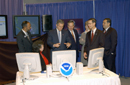 Pres Bush and NOAA staff at display table