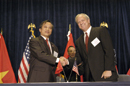 Participants congratulate each other during the US/Vietnam Signing Ceremony