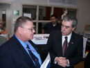 Commerce Secretary Carlos M. Gutierrez visits with a National Oceanic & Atmospheric Administration (NOAA) official at the High Tech High school where he announced a new partnership between NOAA and the school. 
