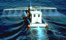 Dispersant application from a smaller vessel