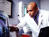Photo of doctor examining test results.