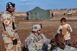 Iraqi army soldiers and Soldiers with 3rd Brigade Combat Team, 101st Airborne Division (Air Assault), hand out meals and water to Iraqi children during a combined medical effort in the town of Albu Farris, Saturday.