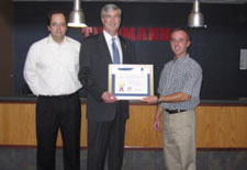 Assistant Secretary Sutton (middle) presents Export Achievement Award to company in Fort Wayne, Indiana.  Click here for larger image.