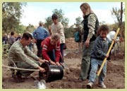 [Photo]: Forest Service employees help during a community tree planing.