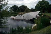 Collapse of sinkholes in limestone terrane causes catastrophic land loss.