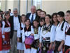 After opening the Citizens Service Center in Suhareke/Suvareka, USAID/Kosovo Mission Director Farbman (back left) and USAID Assistant Administrator Menarchik (back right) thank the young dance troupe for their participation in the ceremony