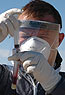 “Martin Gilbert wearing protective gear while testing samples in the field”
