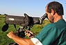 Argentine field assistant, Marcelo Romano, surveying birds through a high powered telescope, in San Javier, Argentina