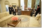 President George W. Bush gives a tour of the Oval Office after the signing of the Presidential Proclamation to Commemorate the 15th Anniversary of the Americans with Disabilities Act in the Oval Office Tuesday, July 26, 2005. President George H. W. Bush is pictured at center, left. White House photo by Eric Draper 