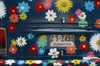 picture of car with multi-colored flowers painted on back