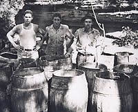 Three Bootleggers In Front Of Barrels Of Moonshine