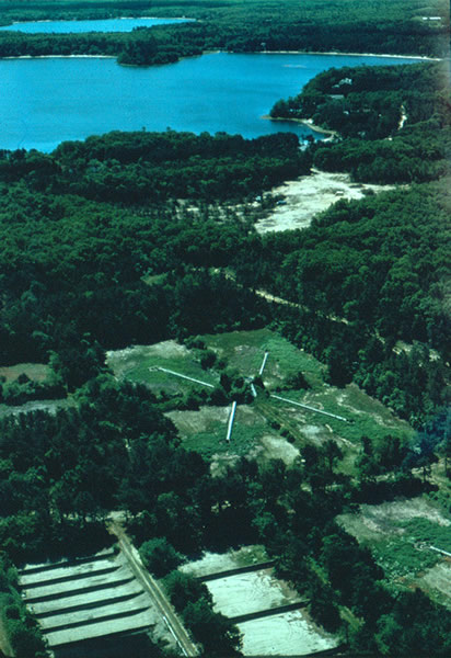 These infiltration beds on Cape Cod, MA, were used for 60 years to dispose of wastewater from a sewage treatment plant. In 1995 their use was discontinued and a large plume of contaminated ground water was allowed to begin to naturally restore itself. USGS investigations of the natural restoration have estimated that it will take decades for the ground water to return to pristine conditions.