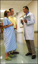 Photo: A healthcare professional consulting with expecting parents.