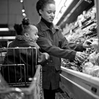 Photo of a mother and young child grocery shopping