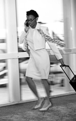 Picture of a woman walking through the airport in a hurry
