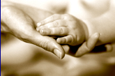 Parent Holding Infant's Hand.
