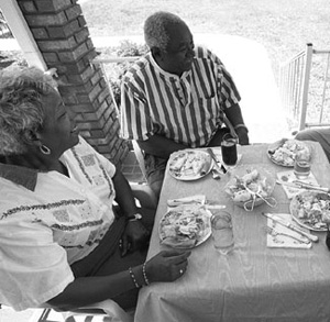 Photo of a couple eating at a friend's home