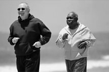 Photo of two older men jogging