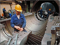 Photo of a man working in an industrial plant.