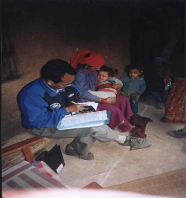 man reading with family in background