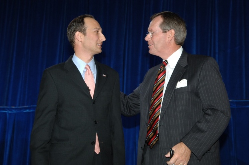 Secretary Mike Leavitt congratulates Deputy Secretary Troy after the swearing-in ceremony.