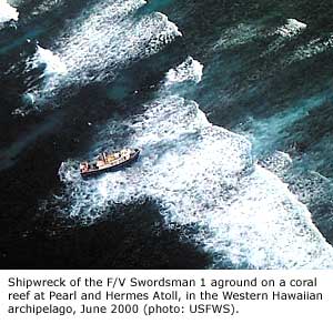 Ship (F/V Swordsman I) aground on a coral reef at Pearl and Hermes Atoll, in the Western Hawaiian archipelago, June 2000.