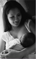 photo of woman nursing baby
