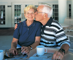 older man kissing wife