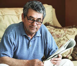 older man reading newspaper