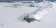 High resolution LIMA data (15 meters per pixel) of the area immediately surrounding McMurdo Station.  If you look really close in the foreground, McMurdo Station can be seen as a few white dots on the open rocky outcrop of Ross Island's peninsula.  The straight lines in the lower left corner of the picture are runways.