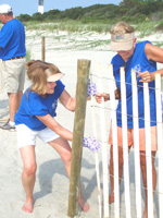 Earth Team volunteer coordinators Winnie Breeding (left) and June Hogg put up sand fencing