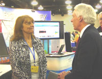 Secretary Ed Schafer (right) chats with NRCS programmer Jennifer Schukar at the NRCS booth (NRCS image -- click to enlarge)