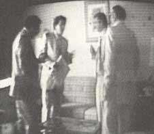 Photograph of individuals caught on tape.