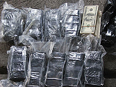 These deep fryers (to the left) concealed $4.4 million dollars in smuggled cash (shown in bundles above). Other money was concealed in voltage regulators and rotisserie ovens. The total amount of the seizure was $7.8 million dollars, the largest seizure in Mexico’s history..