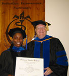 Dr. Powell with his first Ph.D. graduate, Lesa Miles