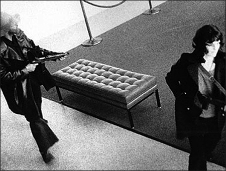 Assault rifle in hand, Hearst joins DeFreeze in robbing a San Franciso bank on April 15, 1974. It was her first crime as a professed SLA member.