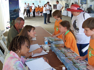 NOAA image of teacher, author and illustrator sighning autographs for children. Please credit  "NOAA."