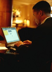 Image of a man working with a laptop