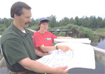 NRCS conservationist reviews conservation plans with landowner