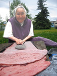 Marie Meade cleaning a seal skin at her Anchorage home