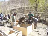 PRT's work with Afghan farmers on a construction project