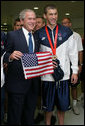 President George W. Bush poses for a photo with U.S. Olympic swimming gold medalist Michael Phelps during his visit Sunday, Aug. 10, 2008 to the National Aquatic Center in Beijing, where Phelps won his first Olympic gold medal in the men's 400 meter individual medley. White House photo by Shealah Craighead