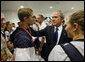 President George W. Bush speaks with U.S. Olympic swimmer and silver medalist Larsen Jensen Sunday, Aug. 10, 2008, at the National Aquatics Center in Beijing. White House photo by Eric Draper