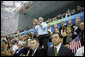 President George W. Bush whistles his support as Michael Phelps swims to his world-record mark in the 400-Meter Individual Medley Sunday, Aug. 10, 2008, at the 2008 Olympic Summer Olympics in Beijing. White House photo by Eric Draper