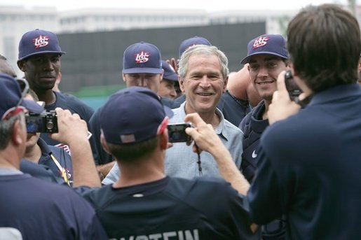 President George W. Bush poses for photos with members of the U.S. Olympic men's baseball team prior to a practice game against the Chinese Olympic men's baseball team Monday, Aug. 11, 2008, at the 2008 Summer Olympic Games in Beijing. White House photo by Chris Greenberg