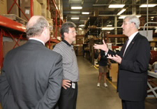 Sutton and Sunnen company officials are seen touring a warehouse. Click for larger image.
